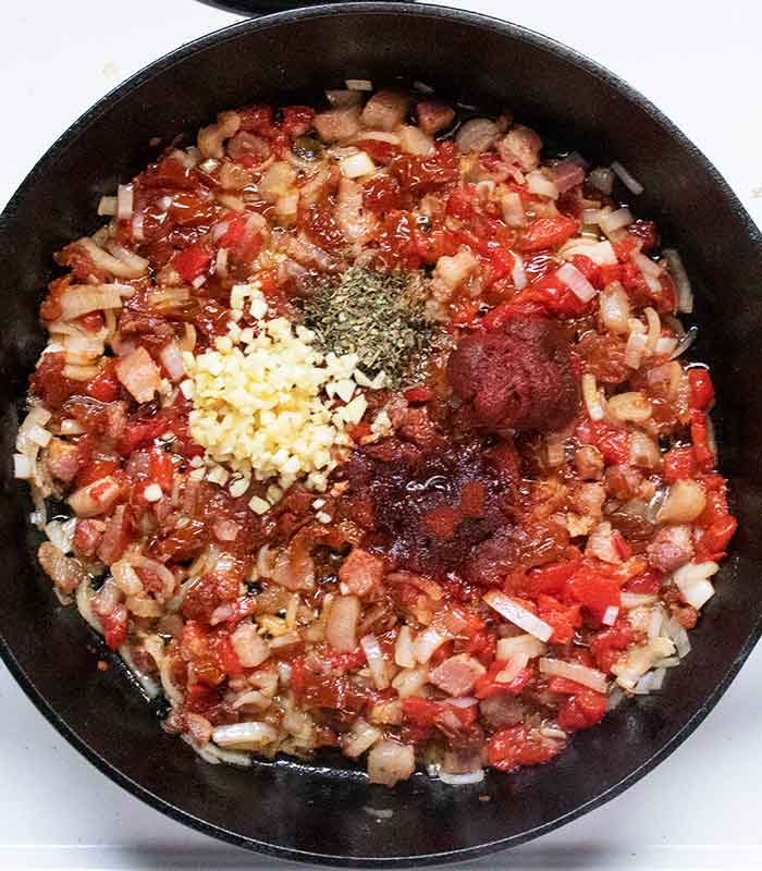 Adding the seasonings to the skillet.