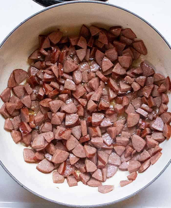 Smoked sausage cooking in the soup pot.