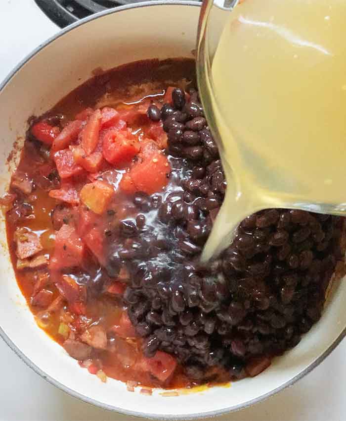 And in go the fire-roasted tomatoes, black beans, and chicken broth.