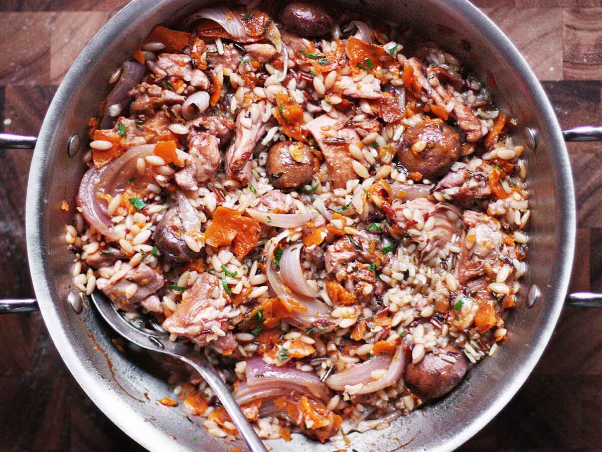 View from above of Autumn Chicken and Wild Rice with Kabocha Ribbons in a stainless steel braiser.