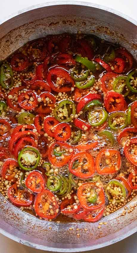 Jalapenos simmering in the brine.