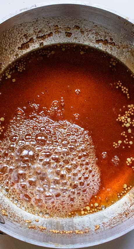 Simmering the brine to thicken it further.