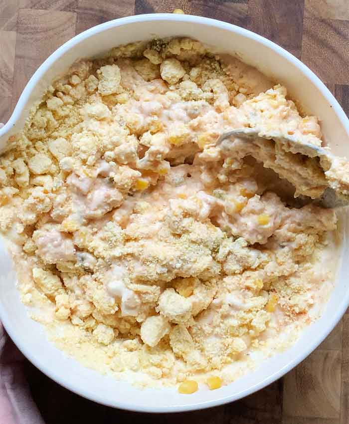 Incorporating the corn muffin mix into the batter base.