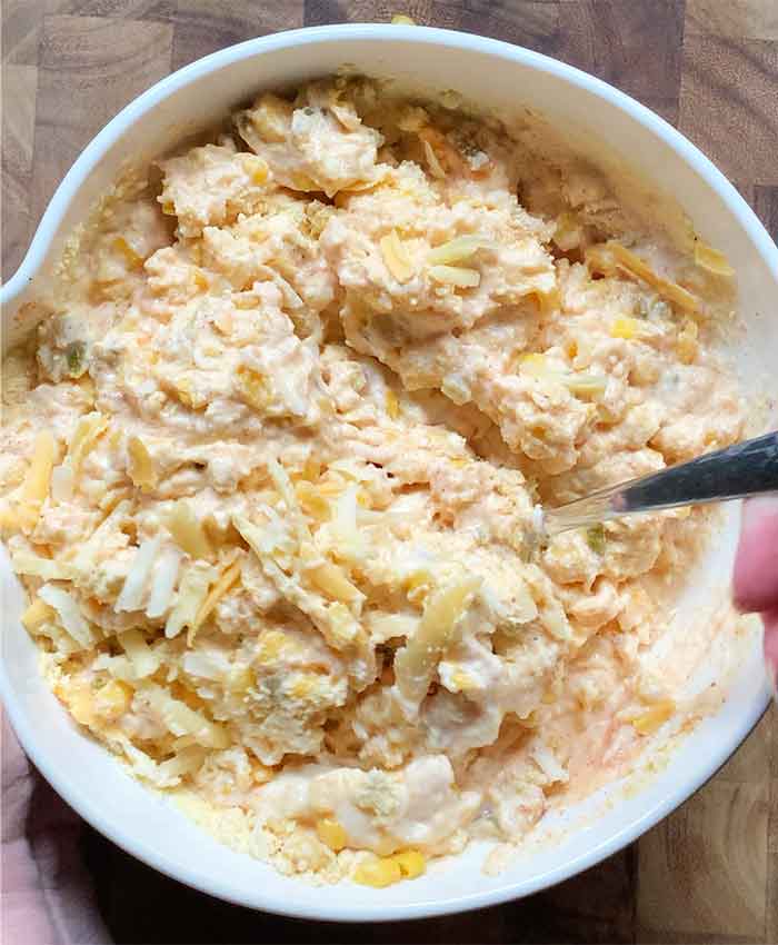 Folding in the shredded cheese.