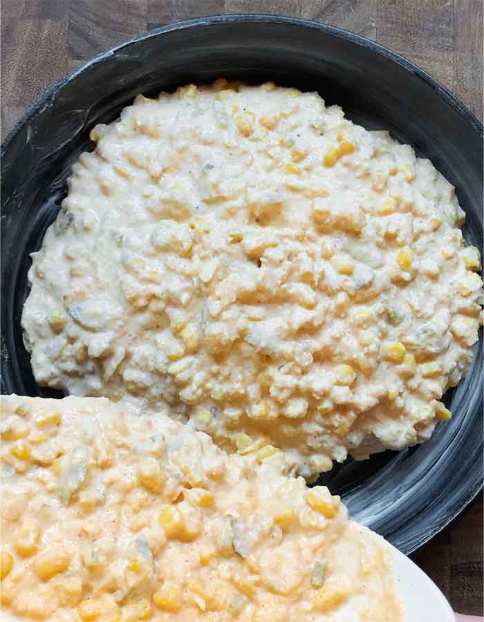 Pouring the batter into a butter-greased cast iron skillet.