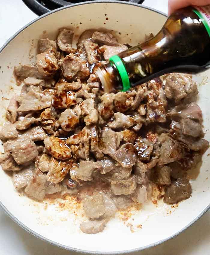 Finishing the steak strips with some soy sauce.