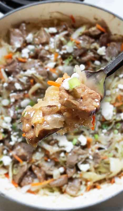 Close-up of a forkful of the finished dish, with the skillet in the background.