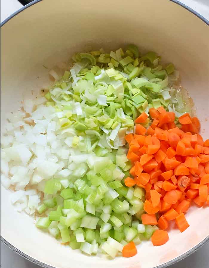 Aromatic vegetables added to the pot.