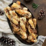 Cheesy Candied Bacon Twists on a brown ceramic platter.