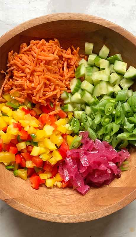 The first layer of veggies go in! (Cucumbers, onions, bell peppers, sugar snap peas, carrots)