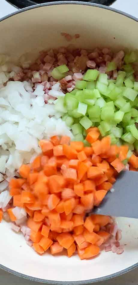 Onions, celery, and carrots cooking in the pot.