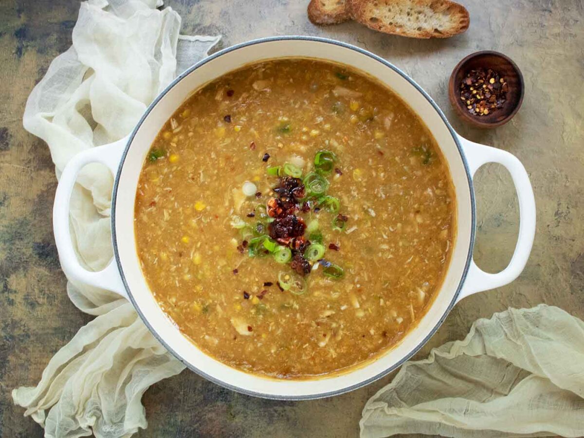 A view from above of Creamy Chicken and Corn Soup in a large white Dutch oven.