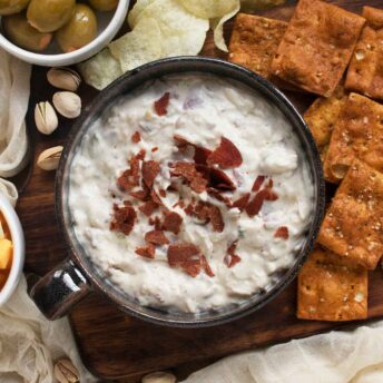 Overhead view of Crispy Pepperoni Ranch Dip in a black ceramic serving bowl.