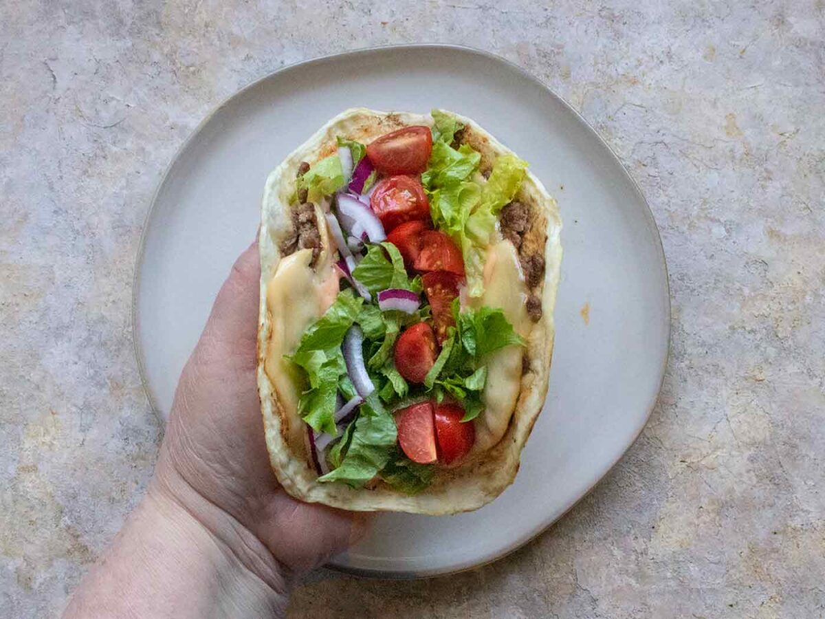 Hand holding a Smash Burger Taco.