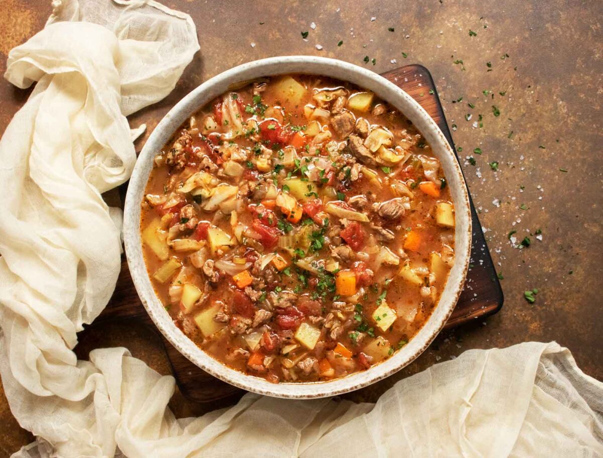 Overhead view of a bowl of Beef and Cabbage Soup.