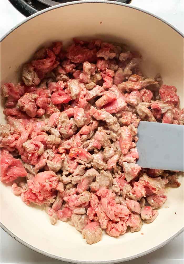 Sirloin strips browning in the pot.