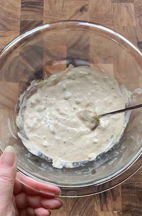 Mixing the crab salad dressing ingredients together in the bowl.