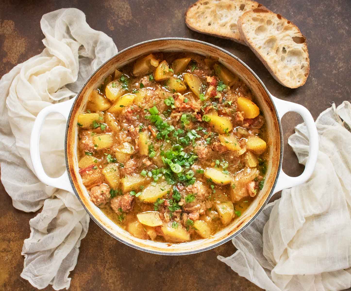 Overhead view of a pot of Dublin Coddle in a large Dutch oven.
