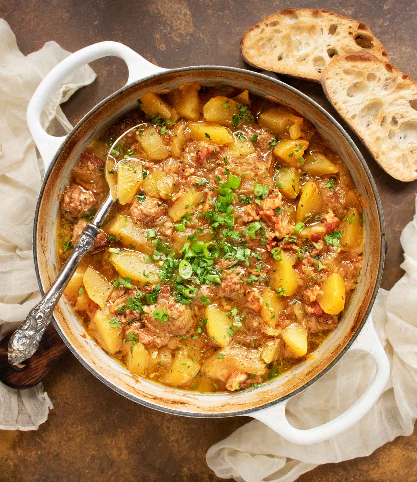 Dublin Coddle in a large pot with a serving spoon.