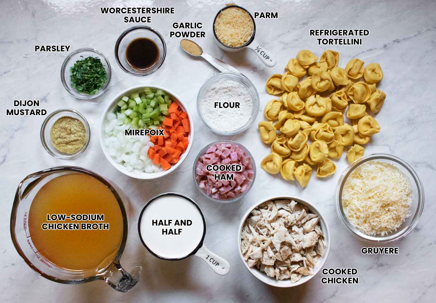 Ingredients for the soup measured out and arranged on a white marble board, with identifying text overlays.