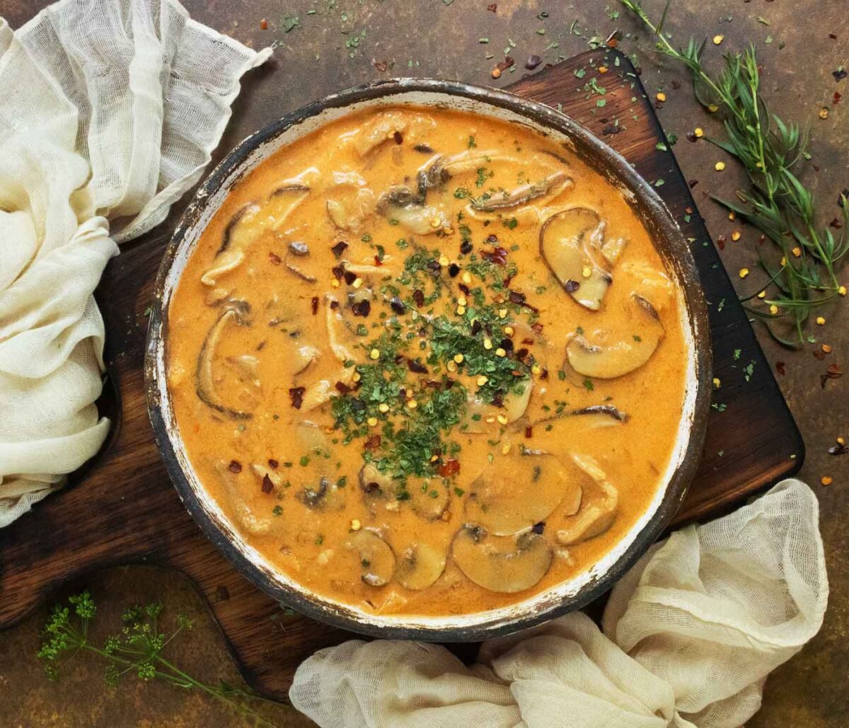 Thai Coconut Mushroom Soup in a rustic ceramic bowl.
