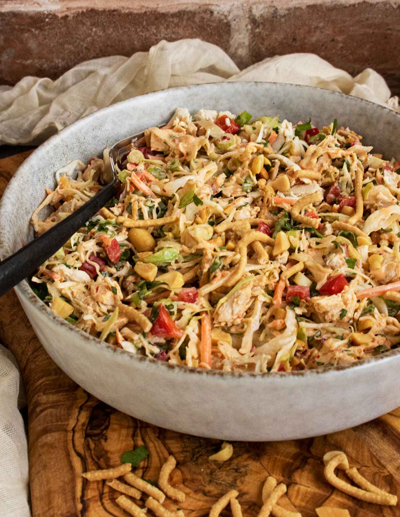 Side-angled view of Chili Crisp Chopped Chicken Salad in a bowl with a fork.