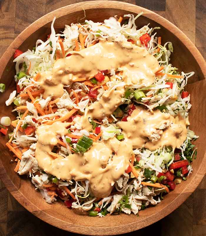 The dressing poured over the top of the tossed salad.