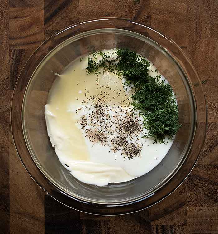 The dressing ingredients in a small glass bowl.