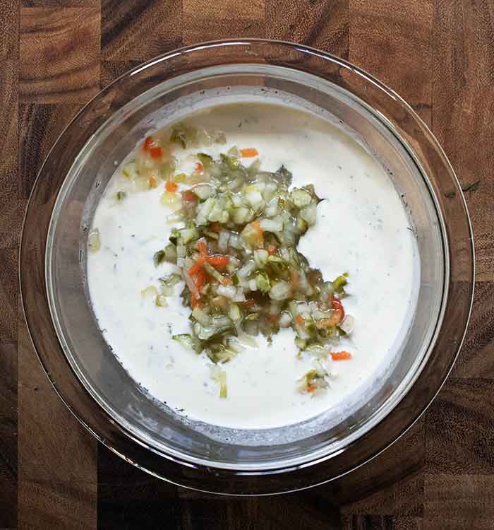 Adding pickle de gallo to the blended dressing.