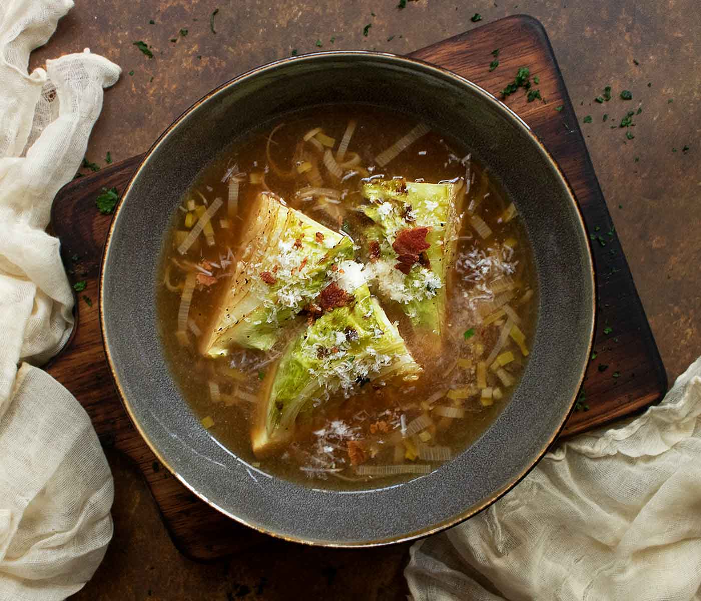 Overhead view of a Roasted Cabbage Broth Bowl in a dark gray bowl.
