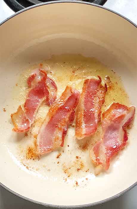 Bacon crisping in the pot.