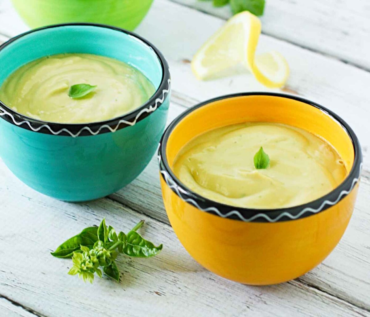 Side angled view of two bowls of Chilled Avocado Soup.