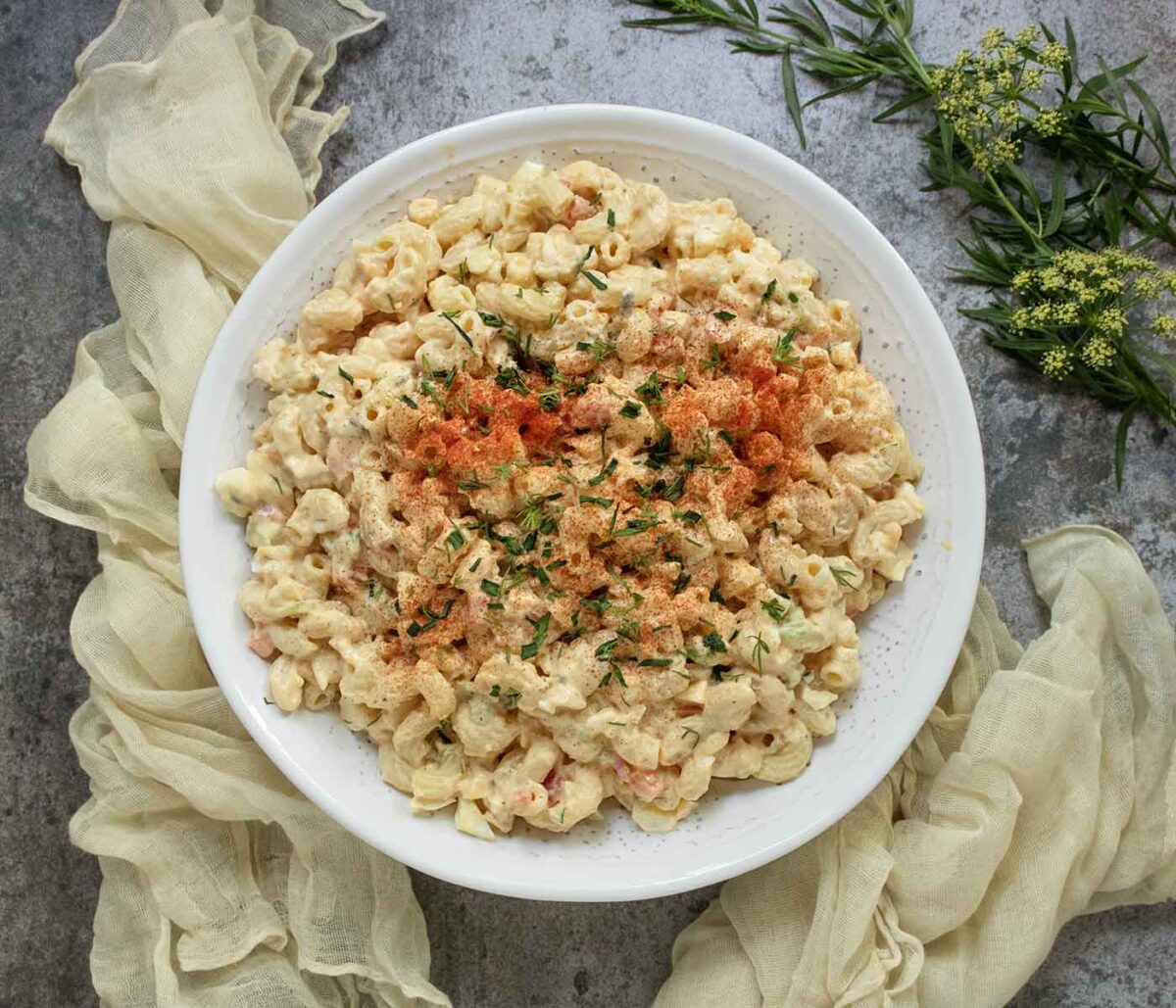 Photo taken from above of Deviled Egg Macaroni Salad in a white serving bowl.