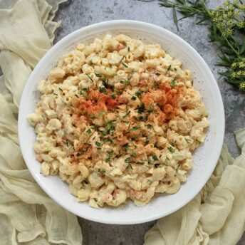 Overhead view of Deviled Egg Macaroni Salad in a white serving bowl.