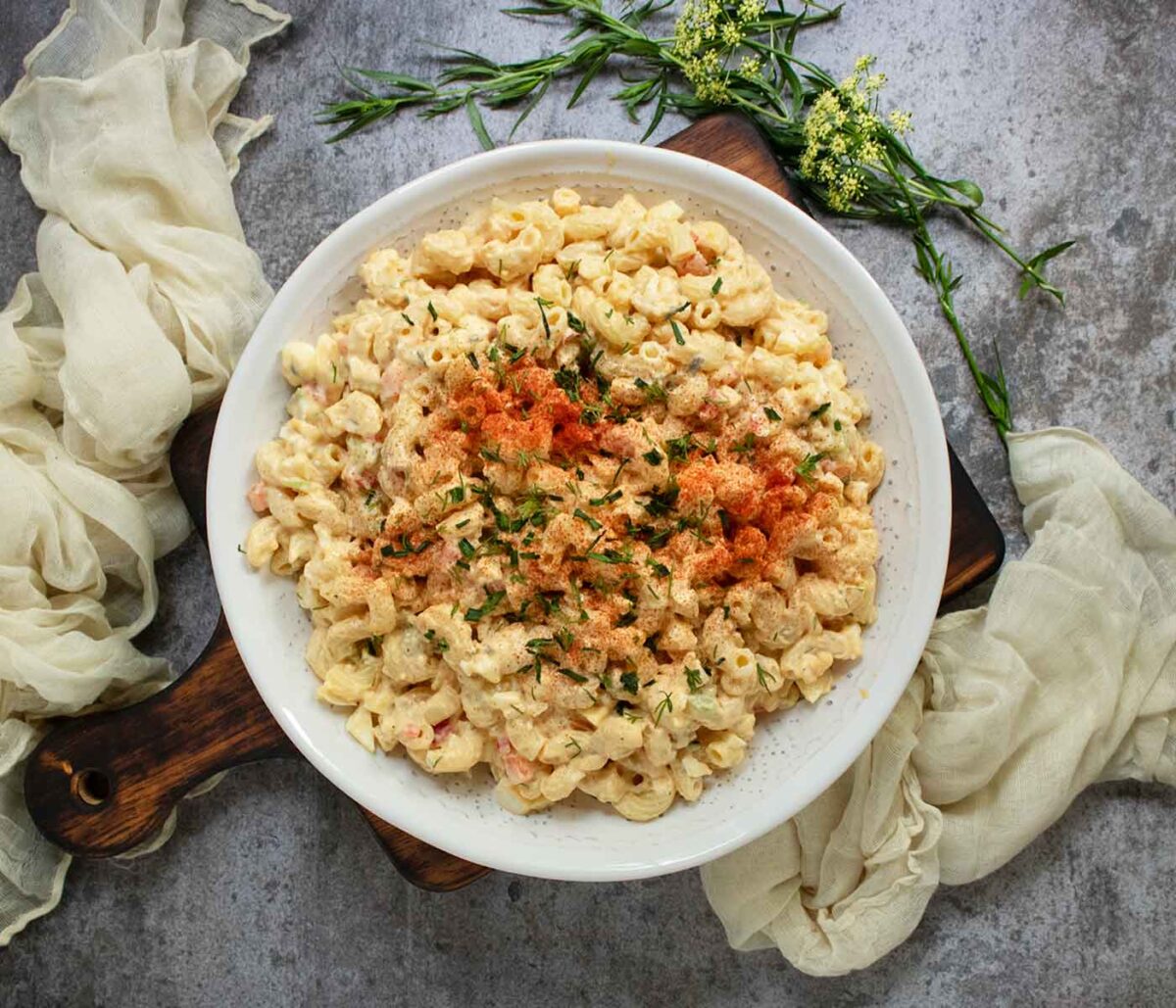 Overhead view of Deviled Egg Macaroni Salad in a white serving bowl.