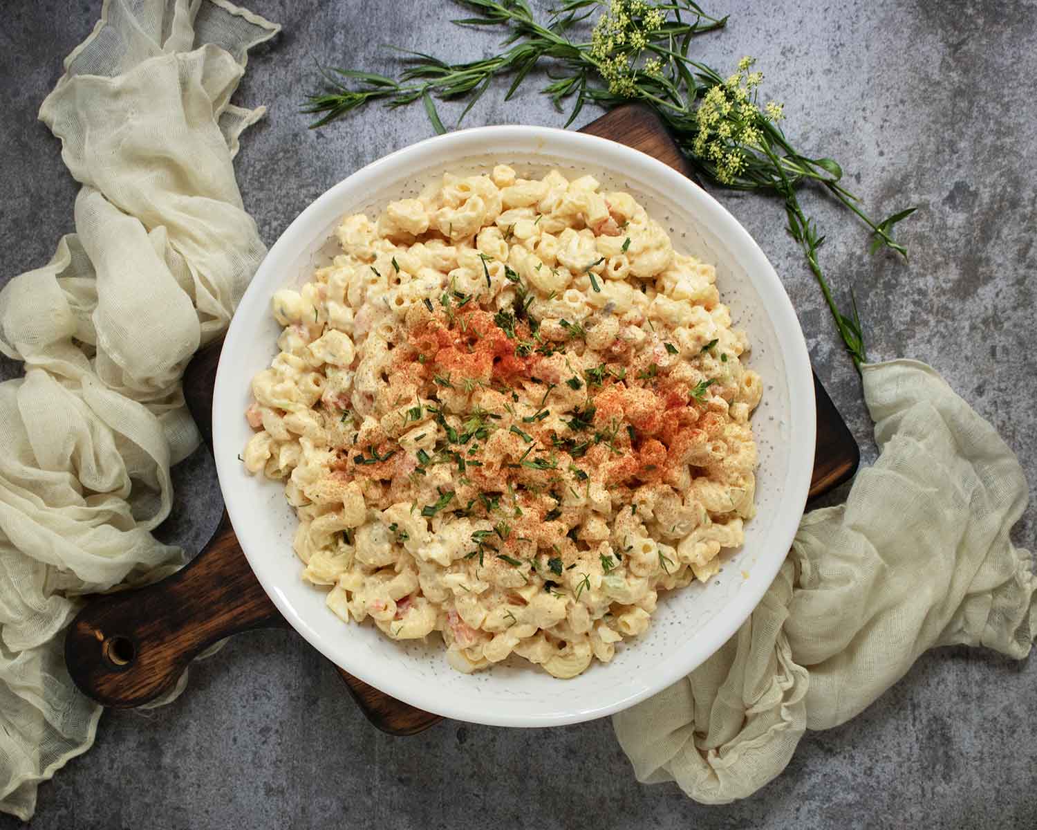 Overhead view of Deviled Egg Macaroni Salad in a white serving bowl.