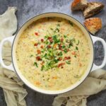 Overhead view of Ham and Corn Chowder in a large soup pot.