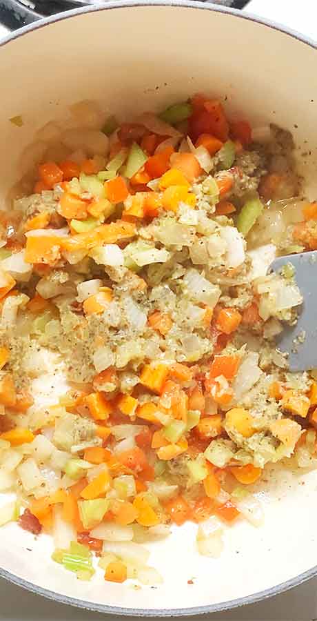 Blooming the herbs and spices and starting the thickening process with the flour.