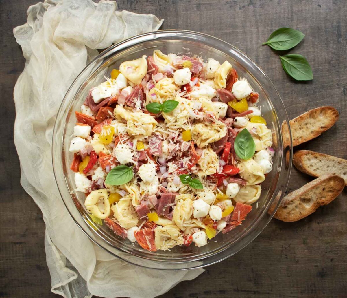 Overhead view of Italian Grinder Tortellini Salad in a large glass serving bowl.
