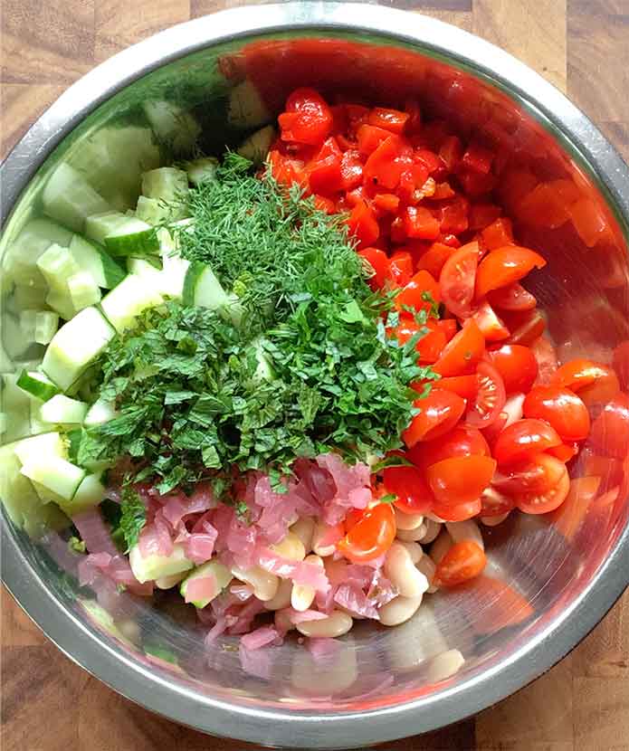 Leafy green herbs sprinkled on top of the veggies.