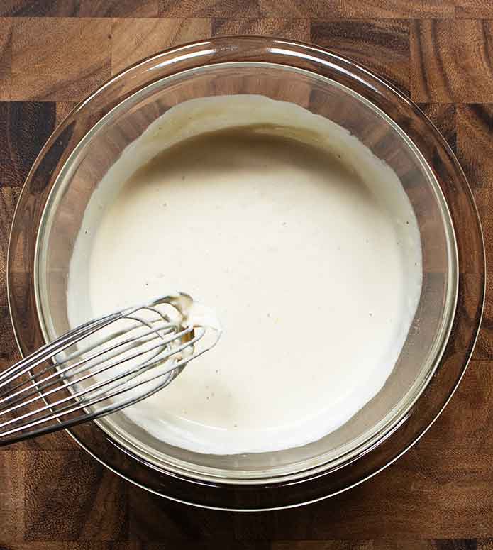 Creamy Caesar dressing whisked smooth.