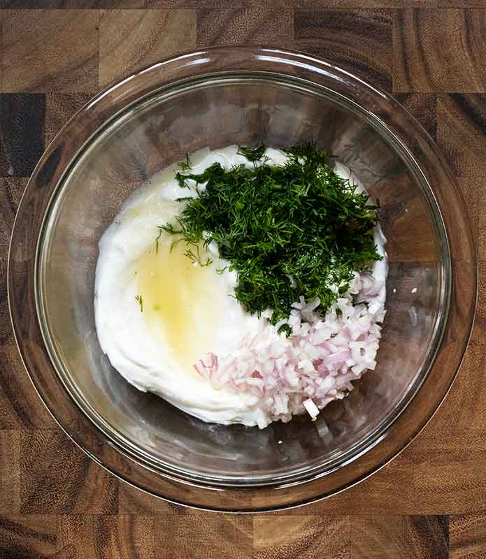The tzatziki dressing ingredients in a glass bowl.