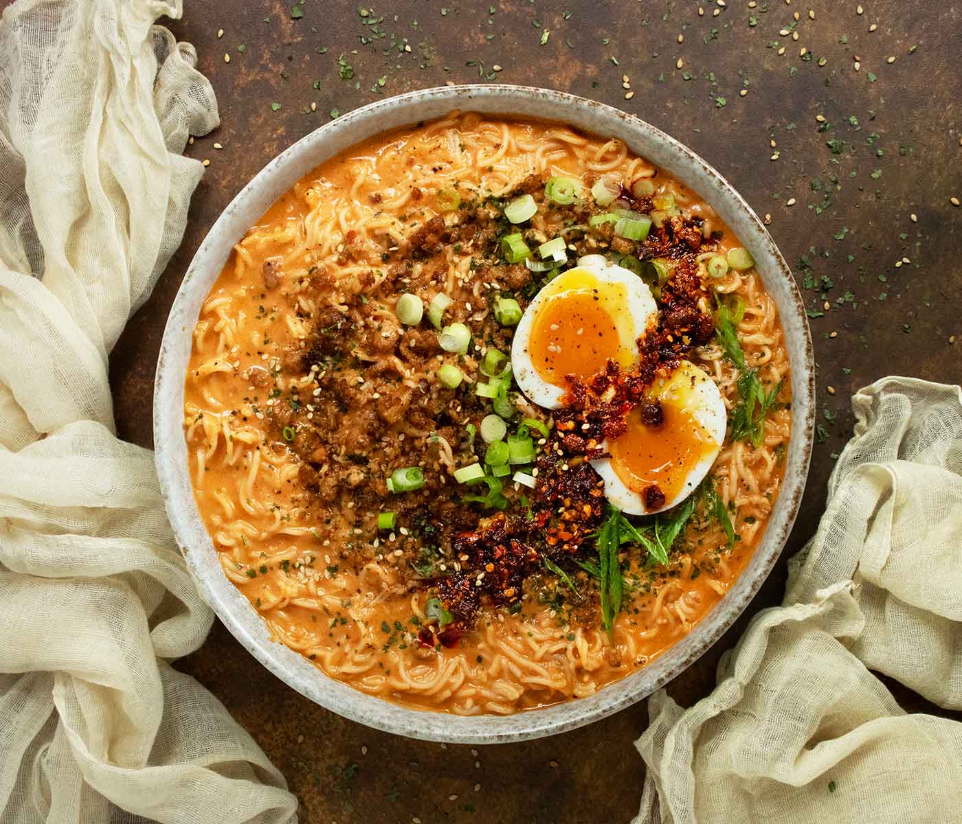 Overhead view of Spicy Peanut Chili Crisp Ramen Noodle Soup in a bowl.