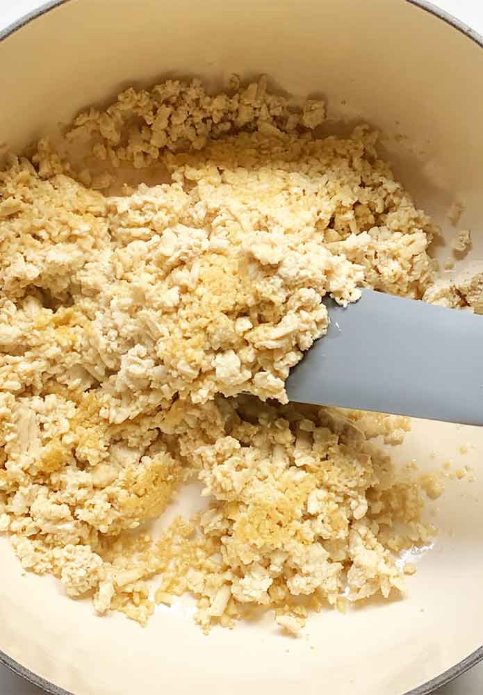 Cooking the shredded tofu in the soup pot.
